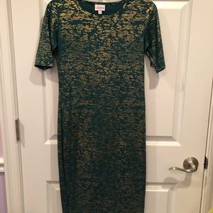 Form fitting green and shiny gold dress